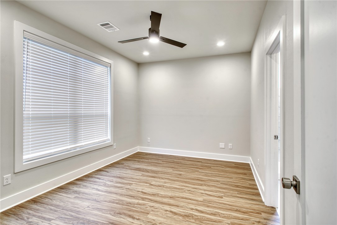 307 Cooner Street, Unit A College Station, TX 77840 - Photo 20 of 35 an empty room with wooden floor and windows
