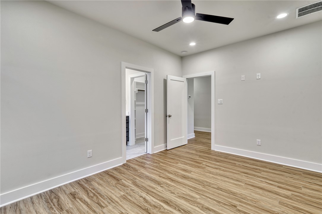 307 Cooner Street, Unit A College Station, TX 77840 - Photo 26 of 35 an empty room with wooden floor and windows