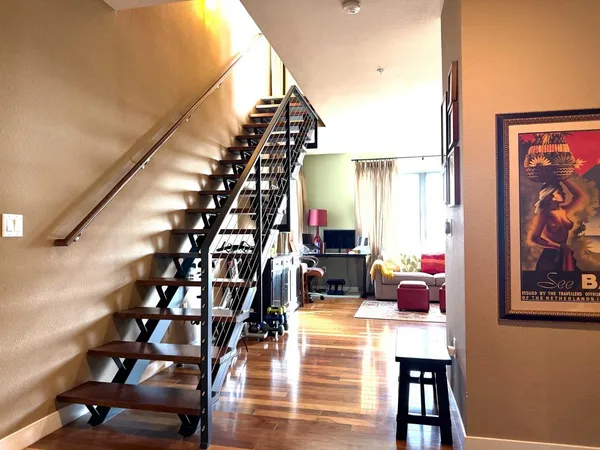 a view of entryway and hall with wooden floor