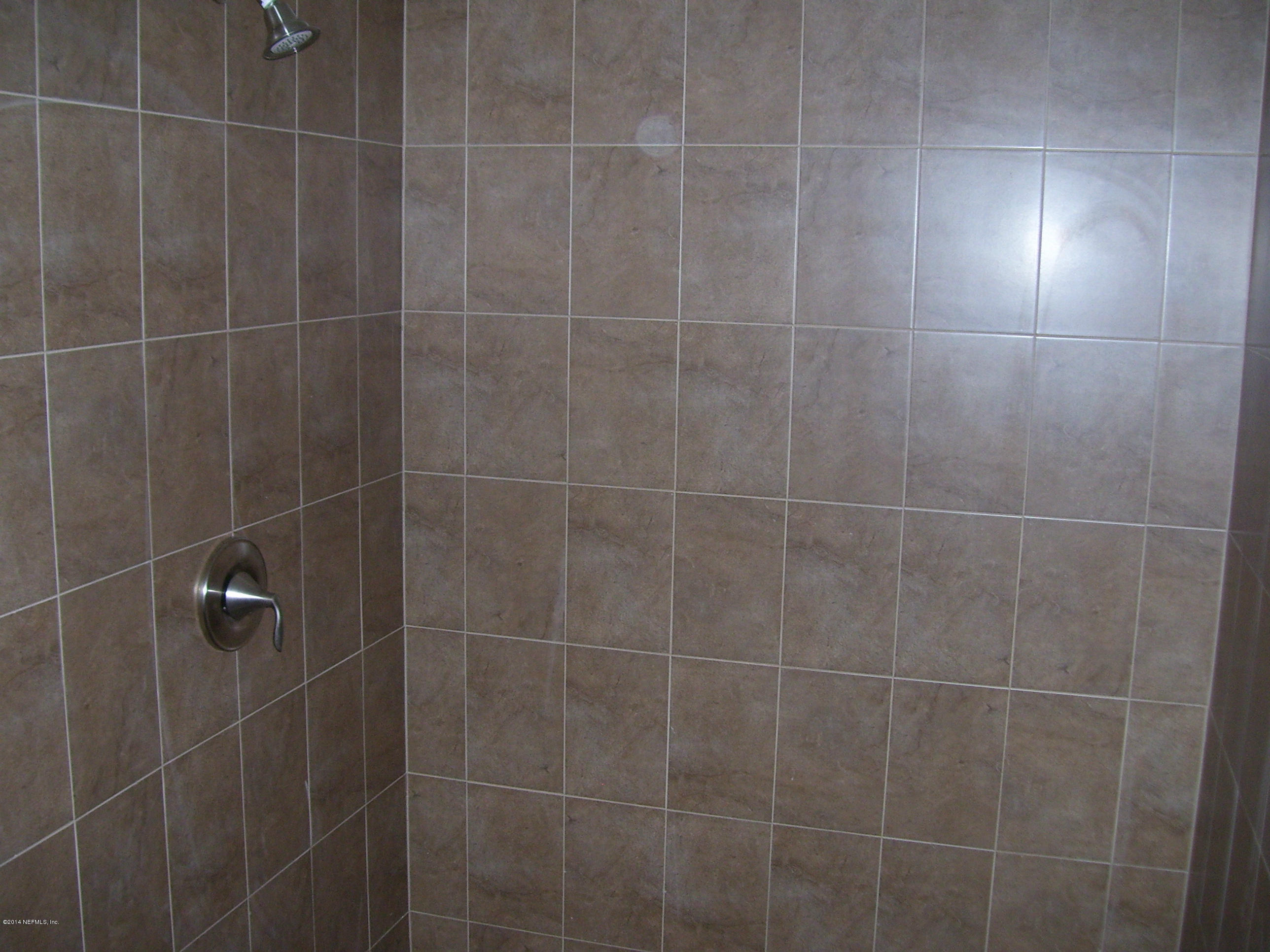 3880 Great Falls Loop Middleburg, FL 32068 - Photo 16 of 32 a bathroom with a shower and a window