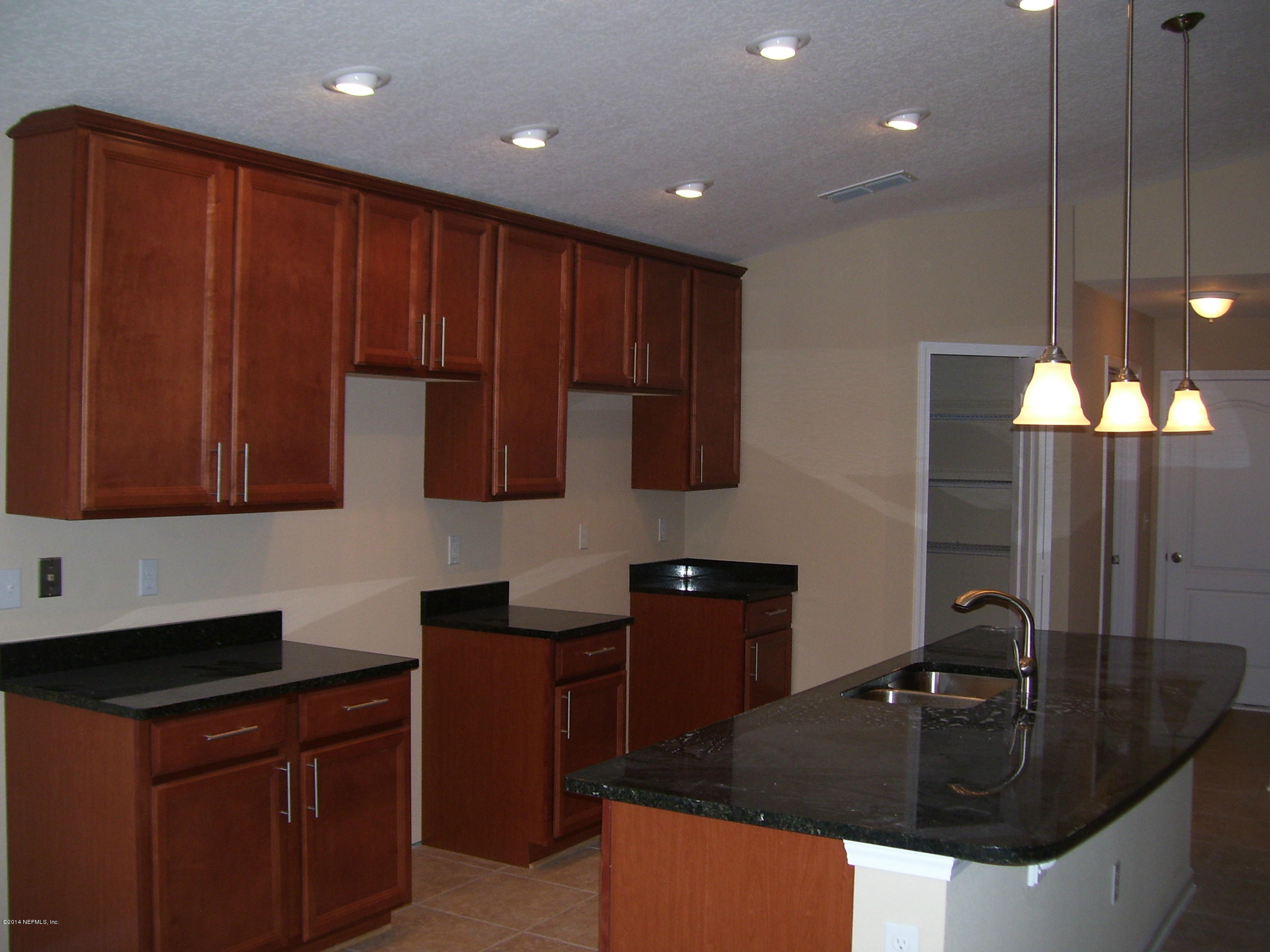 3880 Great Falls Loop Middleburg, FL 32068 - Photo 28 of 32 a kitchen with a sink and cabinets