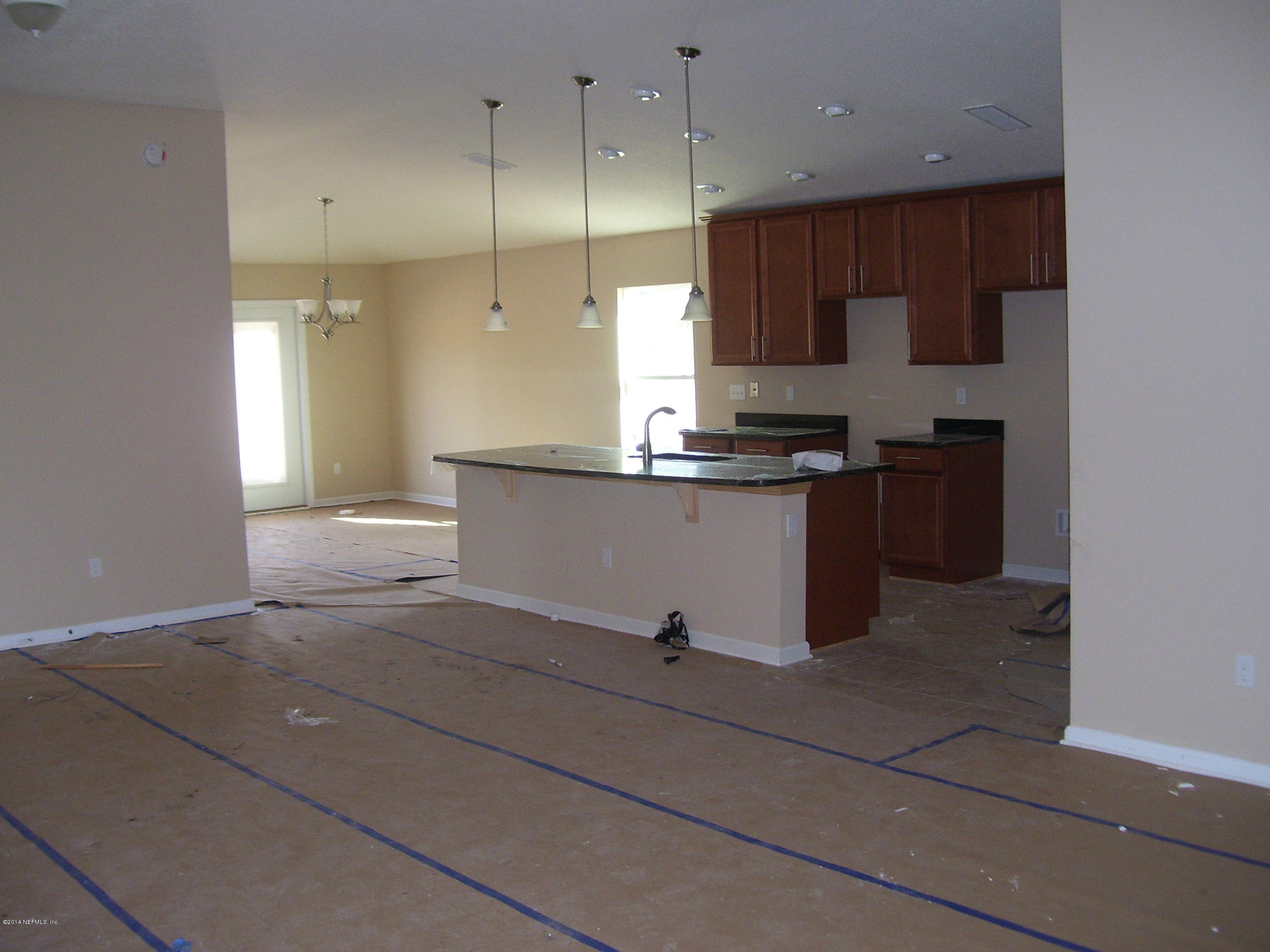 3880 Great Falls Loop Middleburg, FL 32068 - Photo 9 of 32 a kitchen with stainless steel appliances granite countertop a stove a sink and a refrigerator