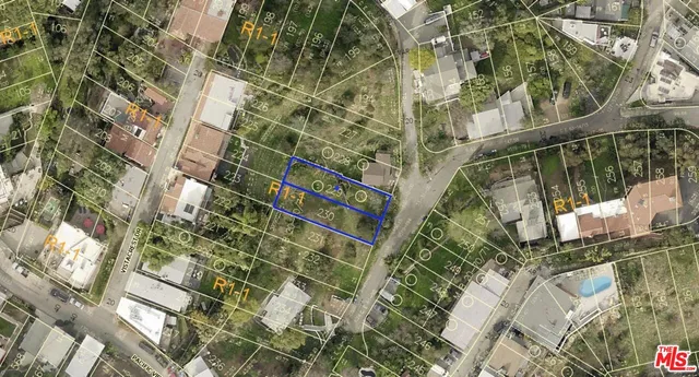 view of a brick house with a tree