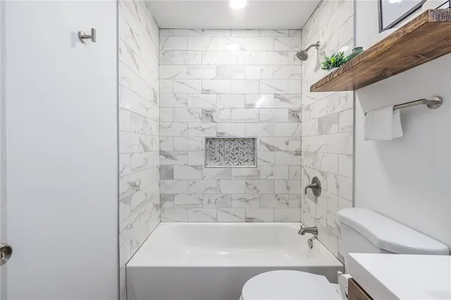 a bathroom with a bathtub and a shower