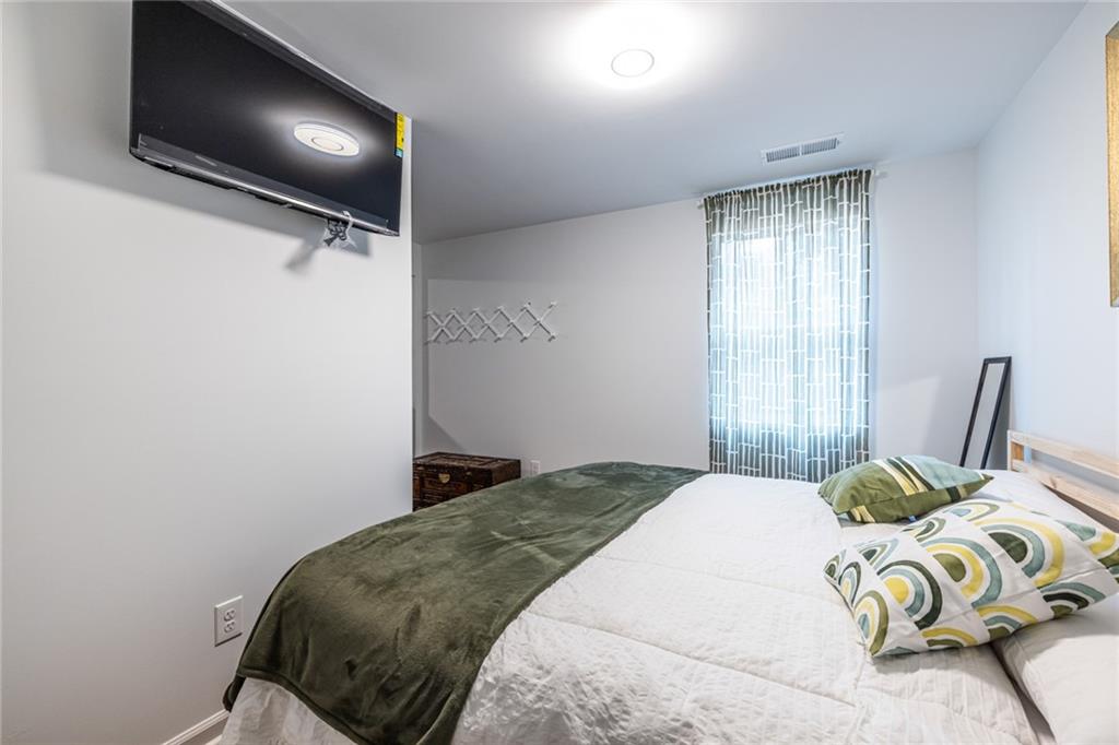 4350 Welcome All, Unit 1 Atlanta, GA 30349 - Photo 17 of 22 a bedroom with a bed and flat screen tv