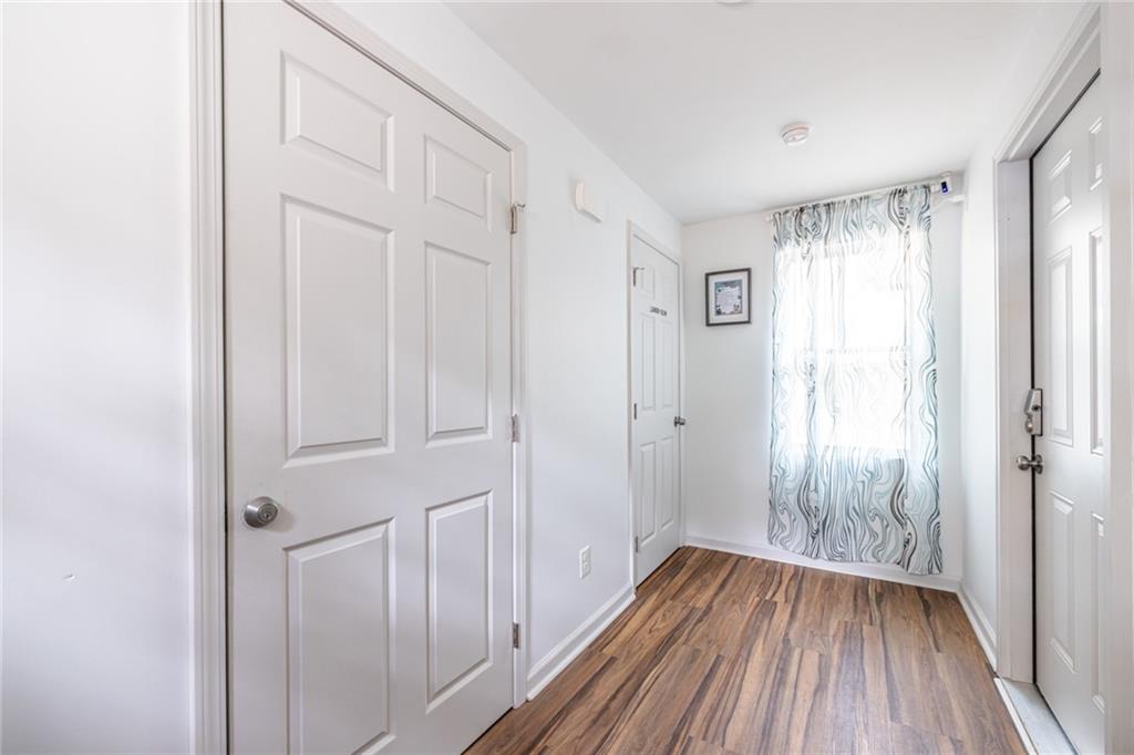 4350 Welcome All, Unit 1 Atlanta, GA 30349 - Photo 18 of 22 a view of a hallway with wooden floor and a bathroom