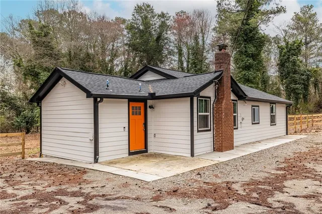 a view of a house with a yard next to a road