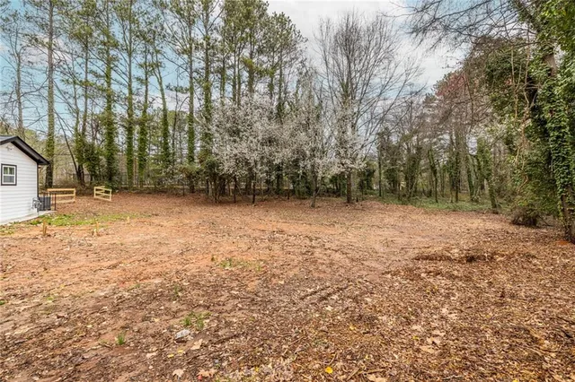 a view of a field with trees in front of it