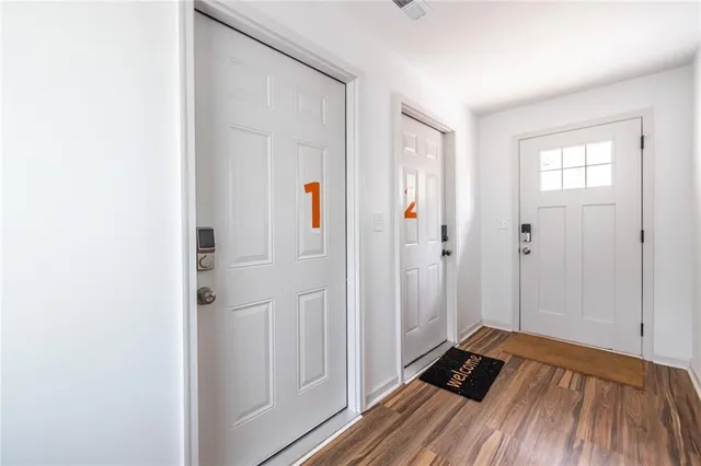 a view of a bedroom with wooden floor and closet