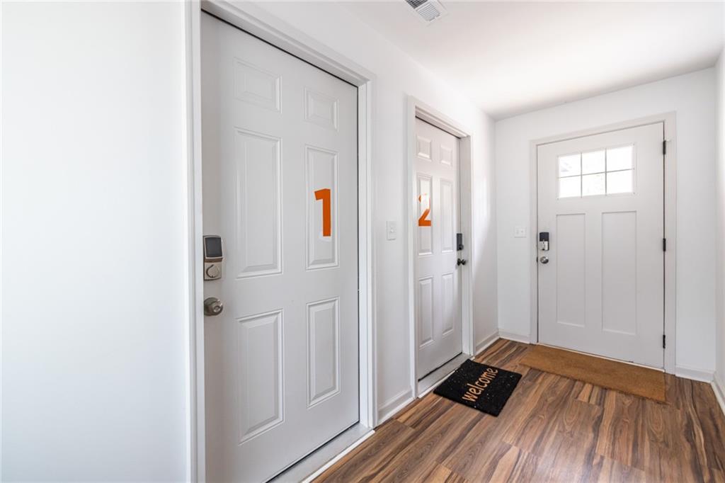 4350 Welcome All, Unit 1 Atlanta, GA 30349 - Photo 3 of 22 a view of a bedroom with wooden floor and closet