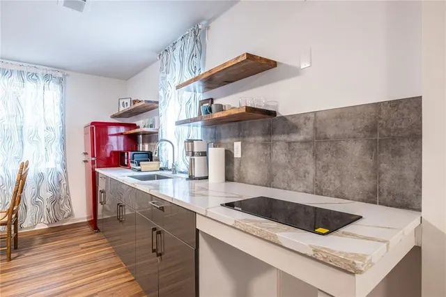 a kitchen that has a sink and a stove in it
