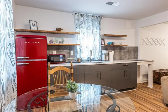 a kitchen with a refrigerator and a sink