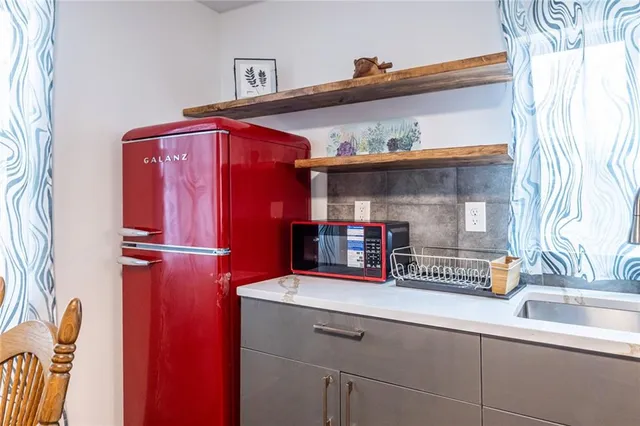 a kitchen with stainless steel appliances a refrigerator and a sink