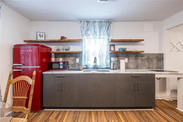 a kitchen with stainless steel appliances granite countertop a sink and cabinets