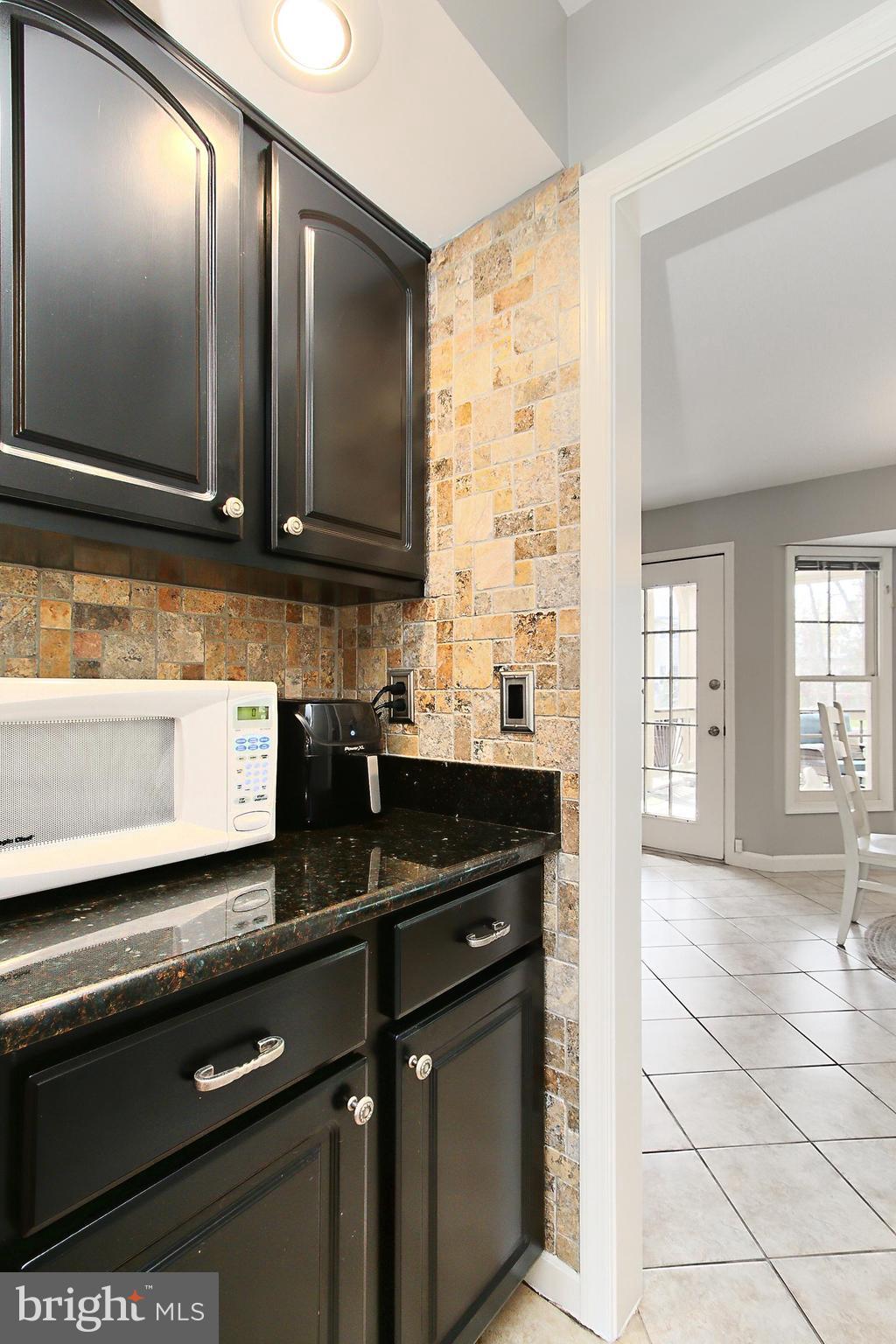 6306 Lee Forest Path Centreville, VA 20120 - Photo 13 of 49 a kitchen with granite countertop a sink and a stove