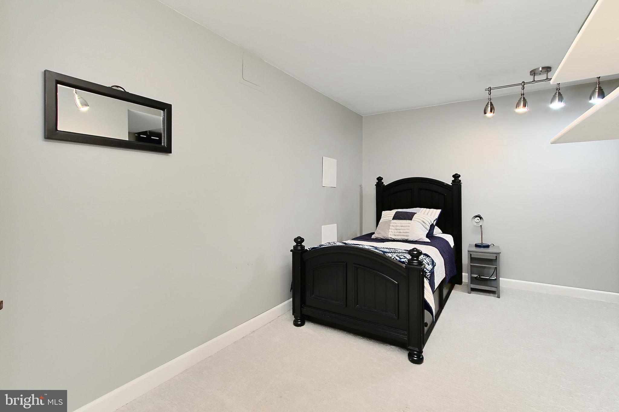 6306 Lee Forest Path Centreville, VA 20120 - Photo 40 of 49 a bedroom with a bed and lamp