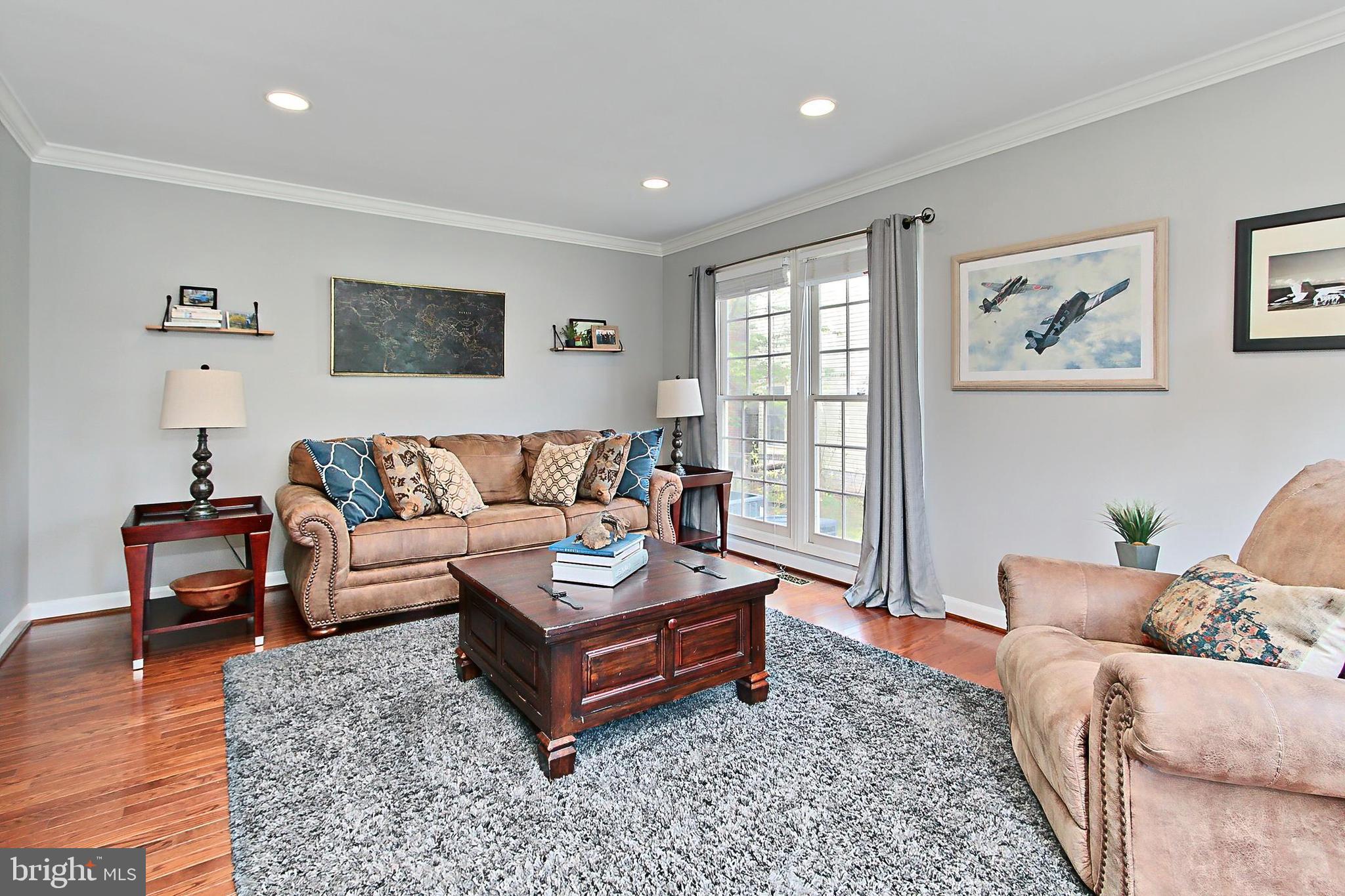 6306 Lee Forest Path Centreville, VA 20120 - Photo 5 of 49 a living room with furniture a rug and a wooden floor