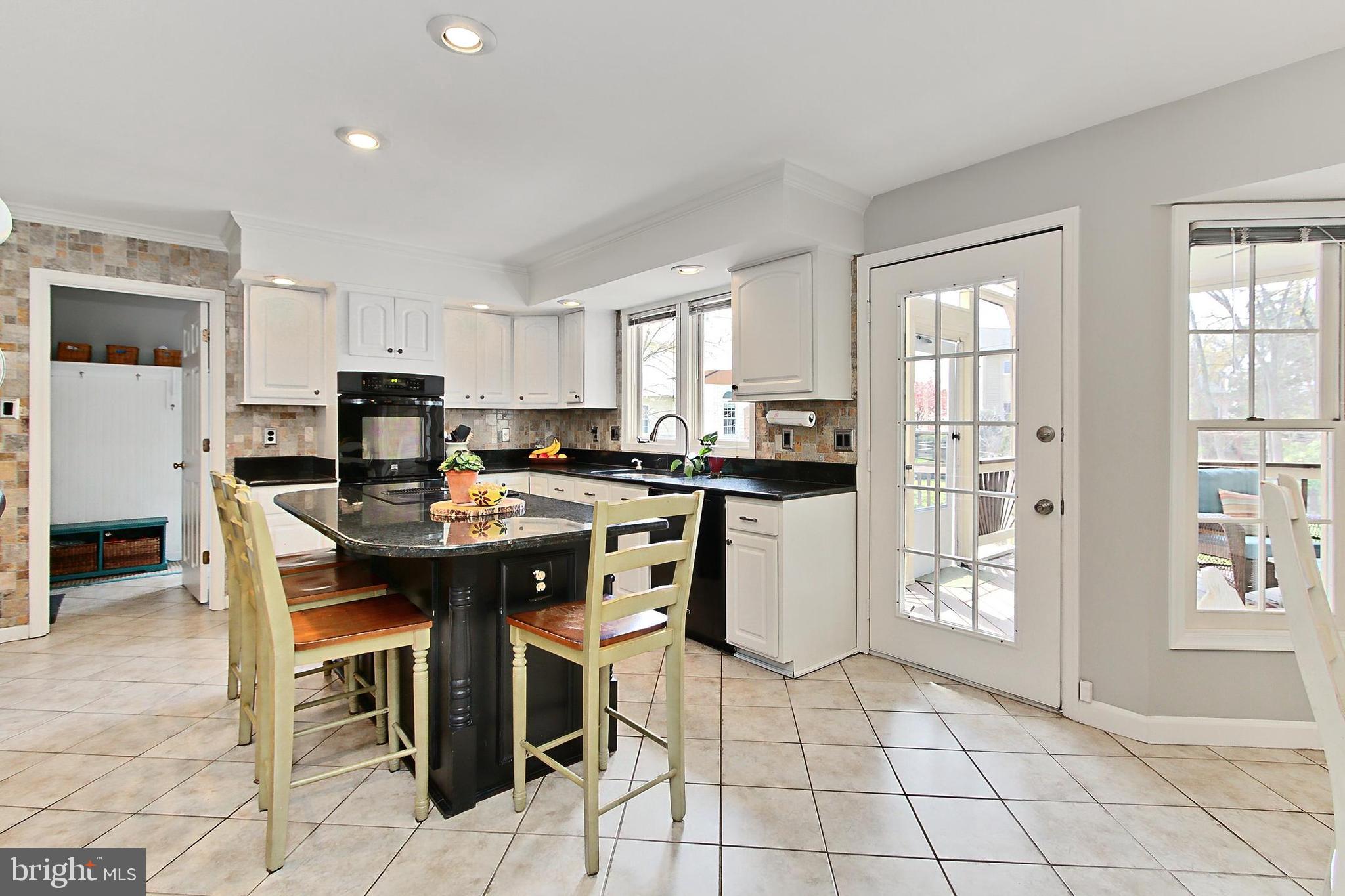 6306 Lee Forest Path Centreville, VA 20120 - Photo 9 of 49 a kitchen with stainless steel appliances kitchen island granite countertop a sink a stove a dining table and chairs