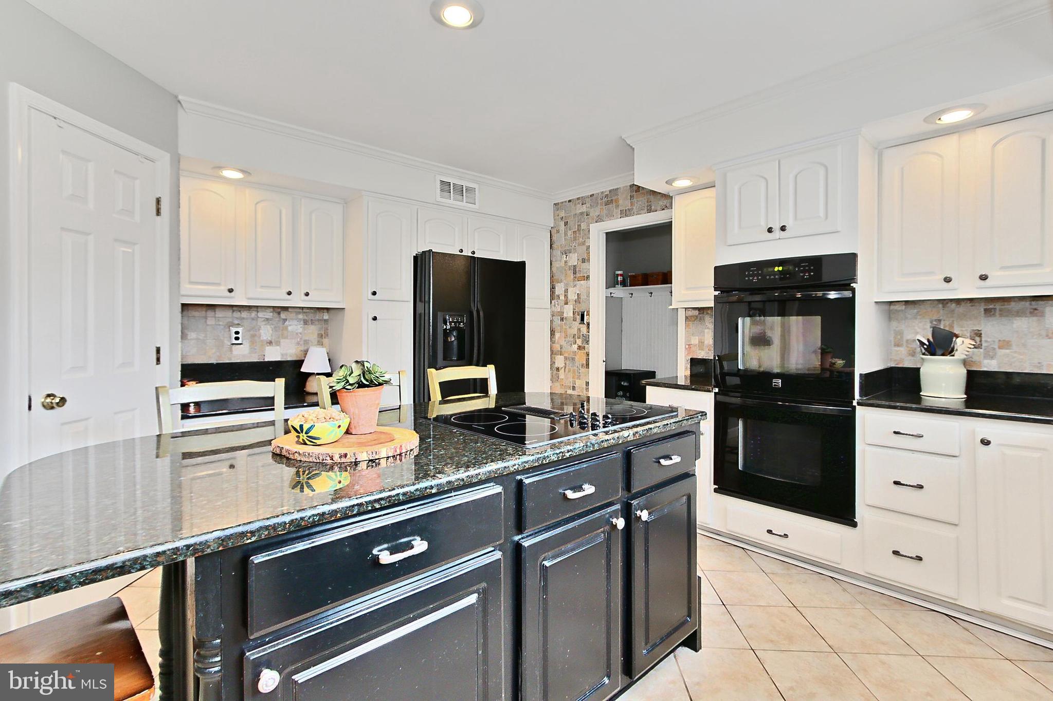 6306 Lee Forest Path Centreville, VA 20120 - Photo 10 of 49 a kitchen with refrigerator a stove and a cabinets