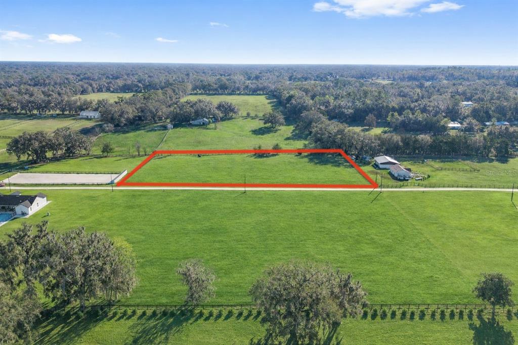 56 Northwest Court Road Reddick, FL 32686 - Photo 15 of 25 an aerial view of a golf course with a big yard