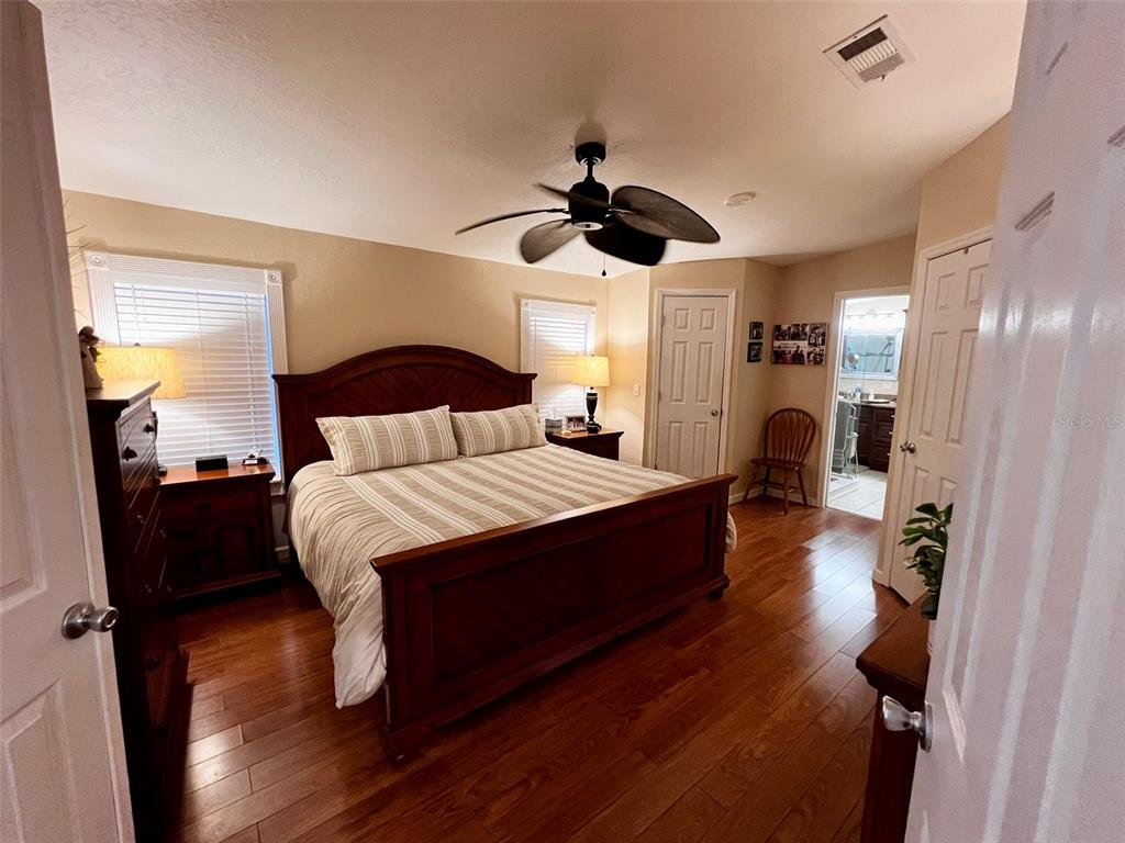 5601 Duncan Road, Unit 96 Punta Gorda, FL 33982 - Photo 12 of 30 a bedroom with a bed and wooden floor