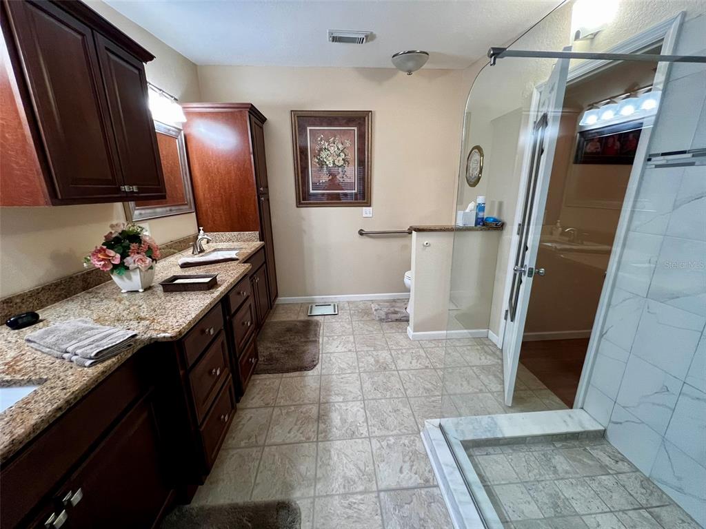 5601 Duncan Road, Unit 96 Punta Gorda, FL 33982 - Photo 14 of 30 a bathroom with a sink a toilet and mirror