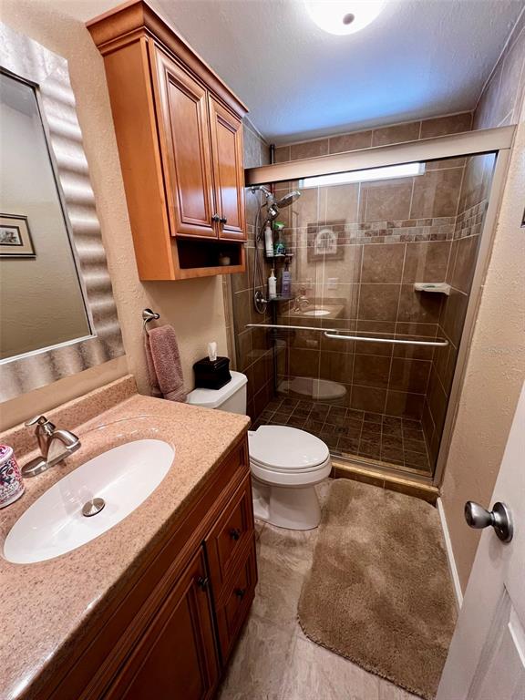 5601 Duncan Road, Unit 96 Punta Gorda, FL 33982 - Photo 17 of 30 a bathroom with a sink a toilet and a mirror