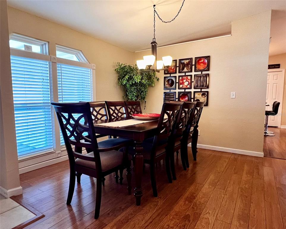 5601 Duncan Road, Unit 96 Punta Gorda, FL 33982 - Photo 2 of 30 a view of a dining room with furniture and wooden floor