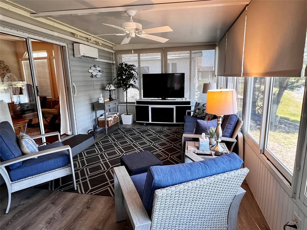 5601 Duncan Road, Unit 96 Punta Gorda, FL 33982 - Photo 21 of 30 a living room with furniture a flat screen tv and a fireplace