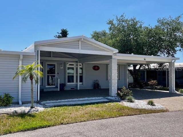 5601 Duncan Road, Unit 96 Punta Gorda, FL 33982 - Photo 27 of 30 a front view of a house with porch