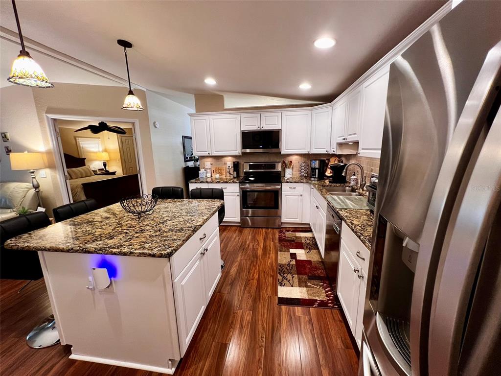 5601 Duncan Road, Unit 96 Punta Gorda, FL 33982 - Photo 8 of 30 a kitchen with sink stove and refrigerator