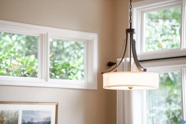 a living room with furniture wooden floor and a large window