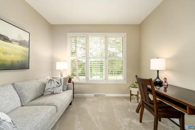 a front view of a house with a garden and trees