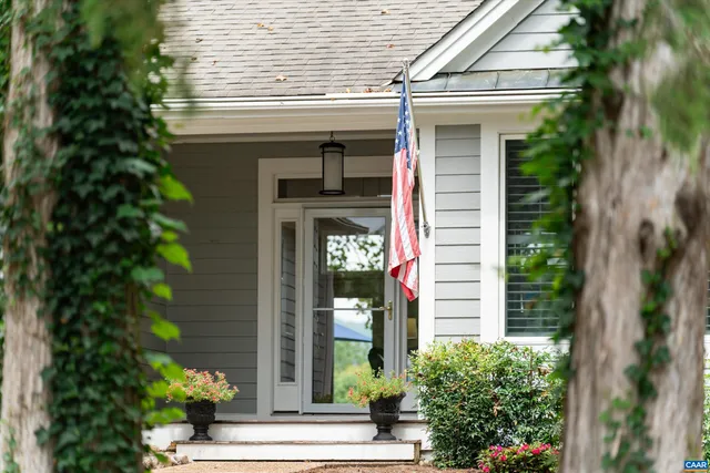 a potted plant is sitting in front of a house