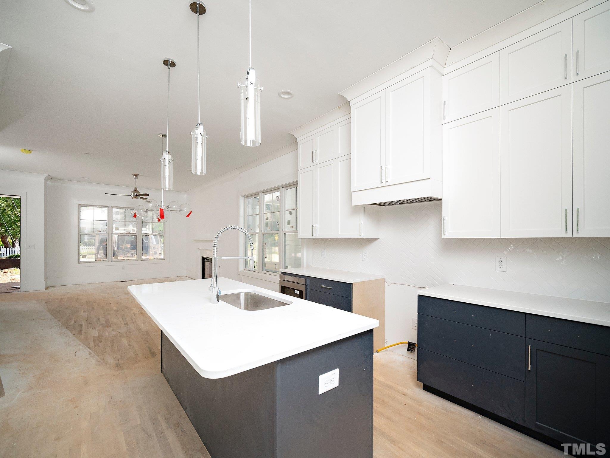 1811 Fairview Road Raleigh, NC 27608 - Photo 13 of 27 a kitchen with kitchen island sink stove and cabinets