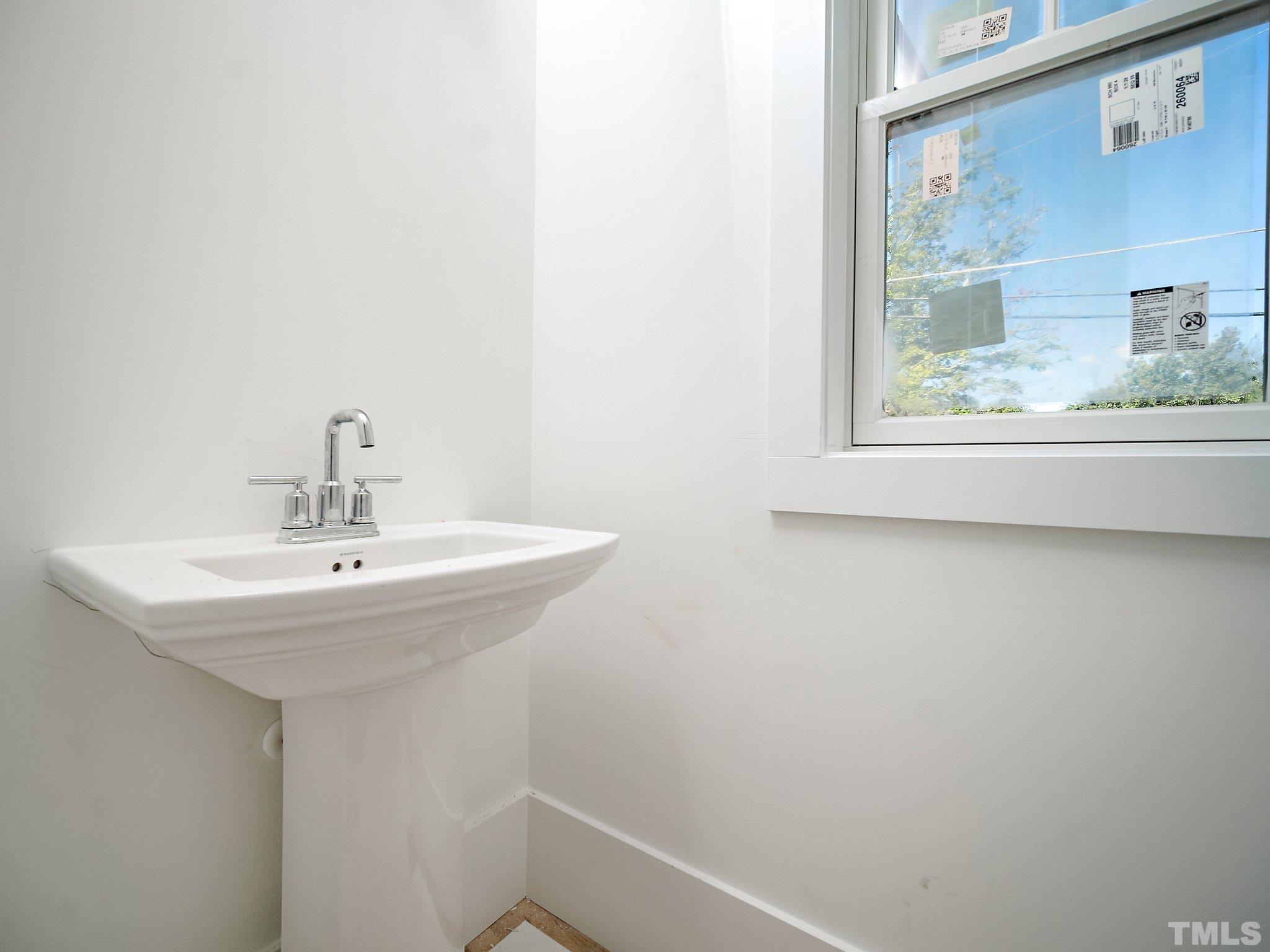 1811 Fairview Road Raleigh, NC 27608 - Photo 16 of 27 a bathroom with a sink and a mirror