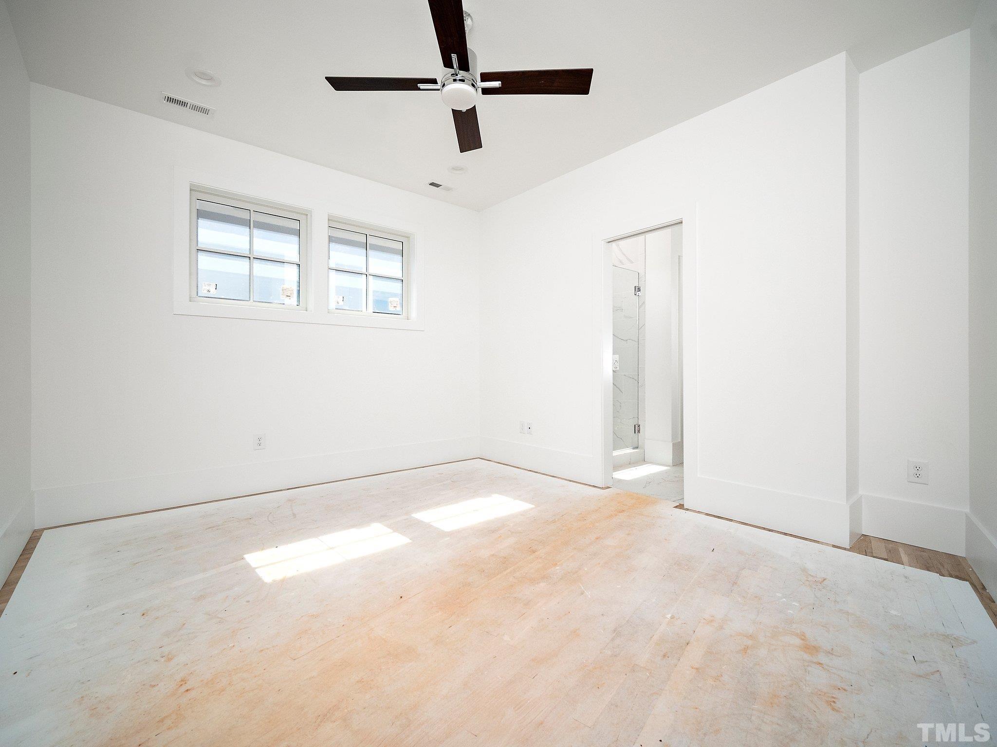 1811 Fairview Road Raleigh, NC 27608 - Photo 17 of 27 en empty room with windows and ceiling fan