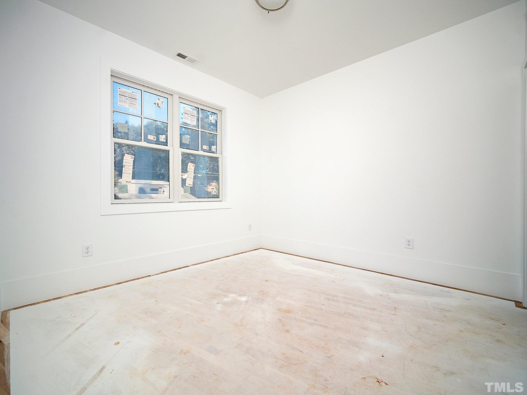 1811 Fairview Road Raleigh, NC 27608 - Photo 23 of 27 an empty room with a window