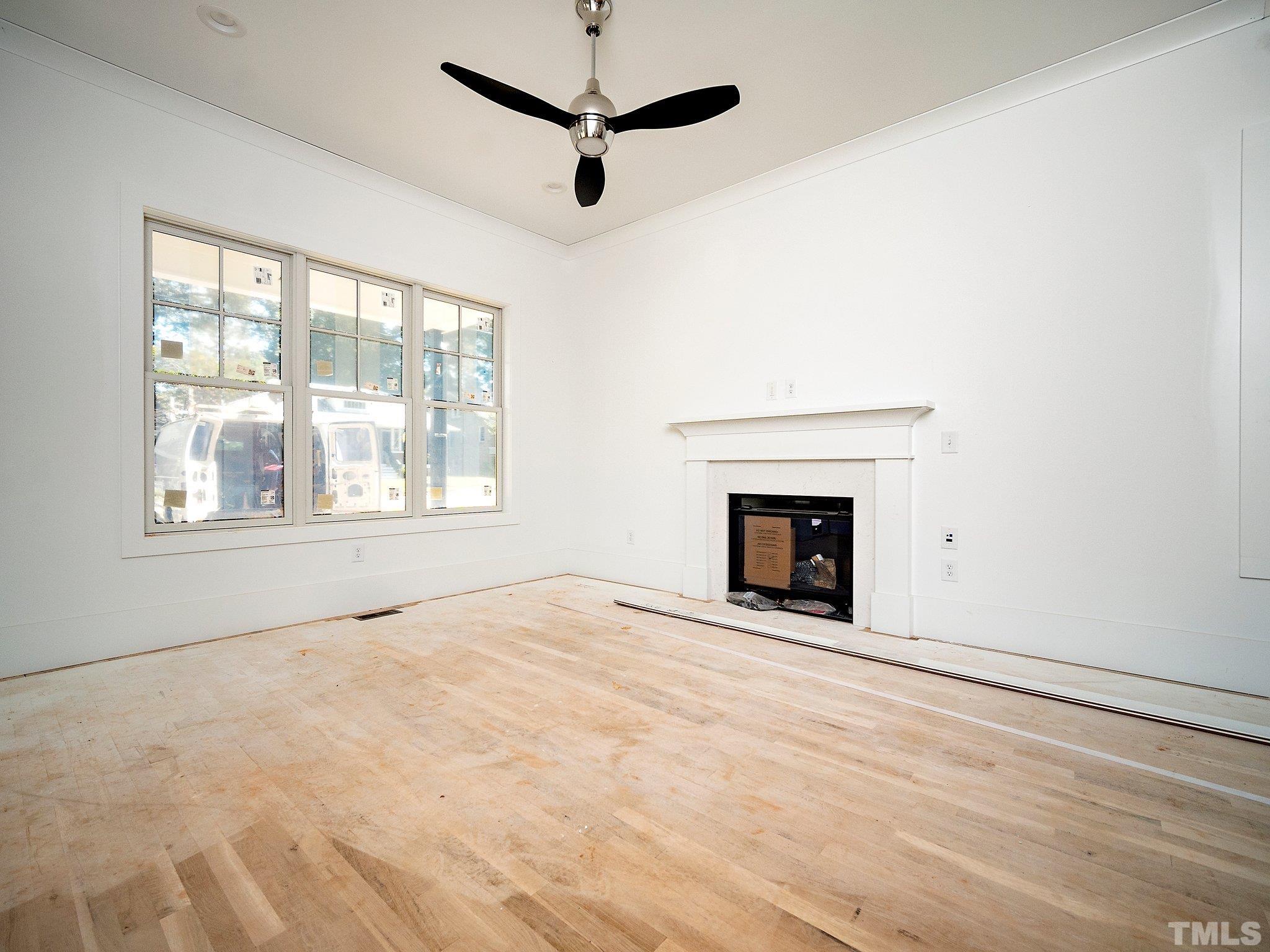 1811 Fairview Road Raleigh, NC 27608 - Photo 7 of 27 a view of an empty room with a fireplace and a window