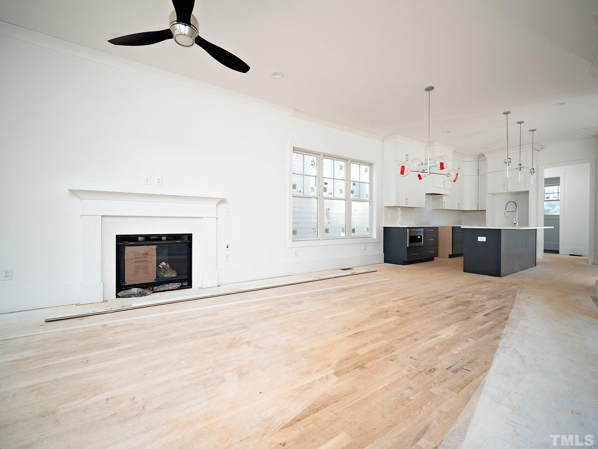 1811 Fairview Road Raleigh, NC 27608 - Photo 8 of 27 a large white kitchen with a fireplace and a window