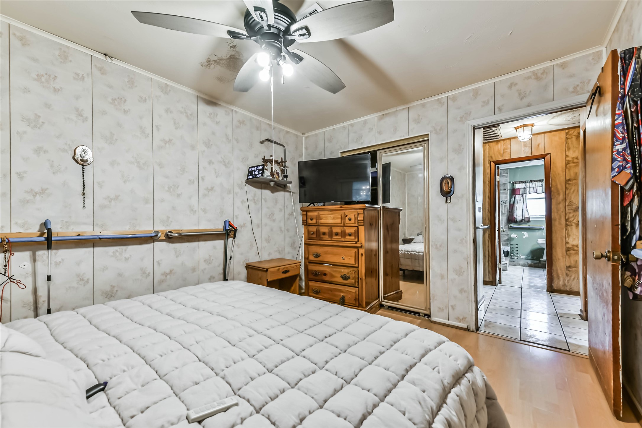 10438 Caxton Street Houston, TX 77016 - Photo 13 of 24 a bedroom with a bed and a chandelier