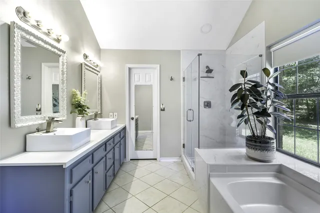 a spacious bathroom with a sink and a large mirror