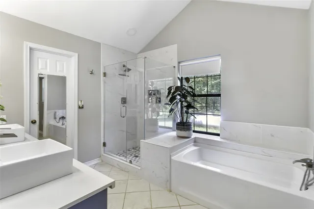 a spacious bathroom with a tub shower and sink