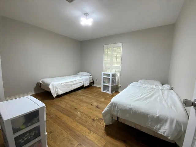 a bedroom with two beds and a tv