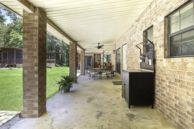 a view of a porch with chairs and backyard