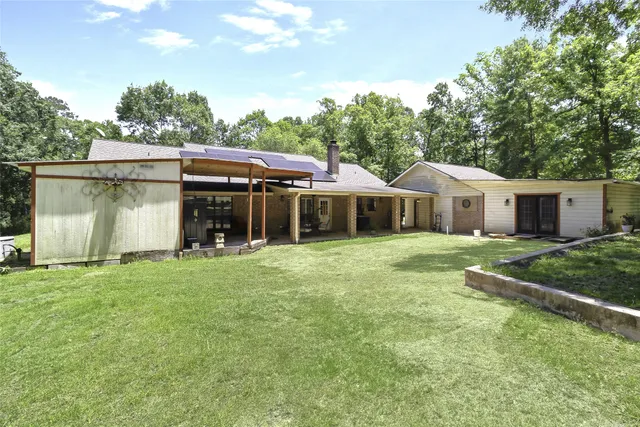 a front view of house with a garden