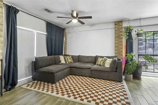 a living room with furniture and a potted plant