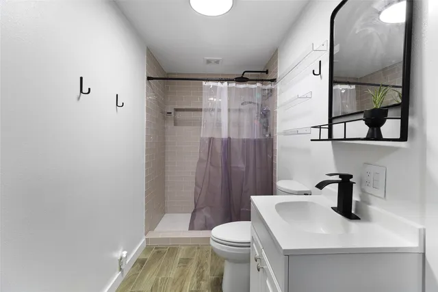 a bathroom with a sink toilet and shower
