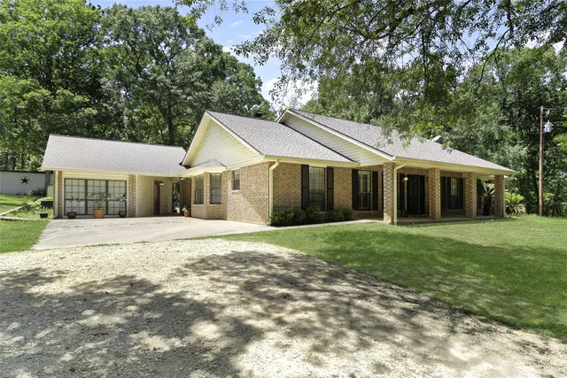 a front view of a house with a garden and porch