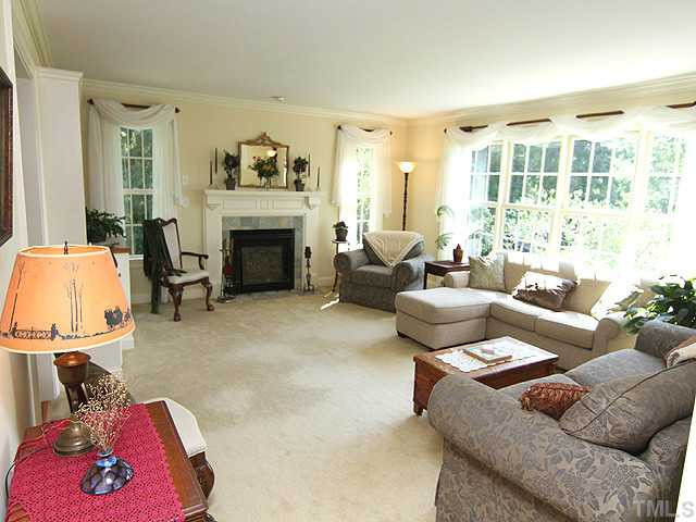 511 Mason Road Durham, NC 27712 - Photo 3 of 25 Bright and spacious main living room with custom built-in shelving and cabinet space. Cozy gas fireplace. Beautiful pastoral views from every window. Living Room